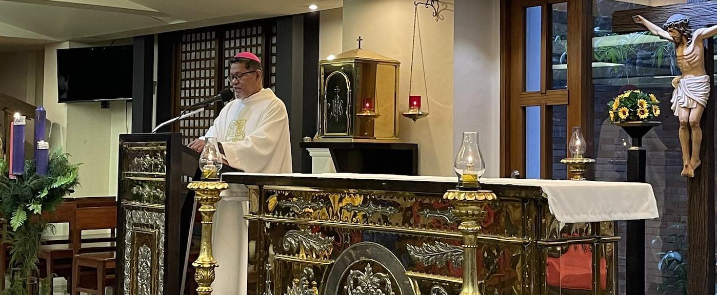 Bishop Severo Caermare presides Christmas Mass with the Laiko Board.